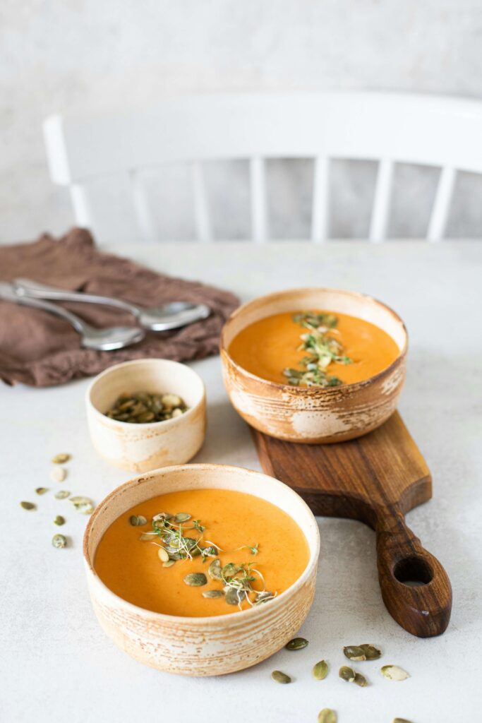 Two bowls of carrot soup.